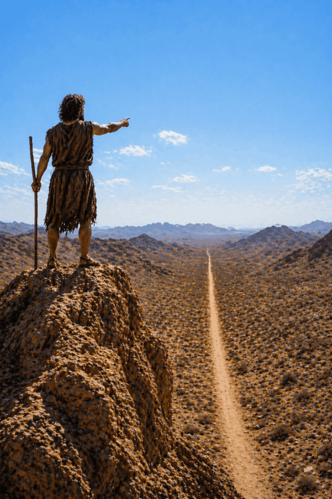 Saint John the Baptist preaching in the wilderness beside the Jordan River, calling the people to repentance and proclaiming, ‘Make straight the way of the Lord,’ as crowds gather to hear his message.